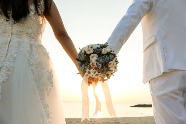 two couple have bouquet at the sunset beach